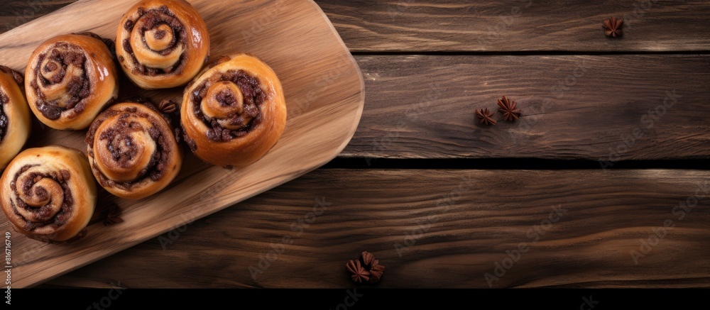 Poster A top down view of delicious raisin swirl buns on a wooden board perfect for breakfast or brunch The image includes ample copy space