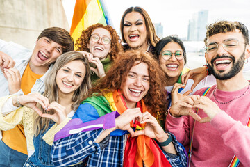 LGBTQ people celebrating gay pride festival together - Diverse friends making heart shape with hands