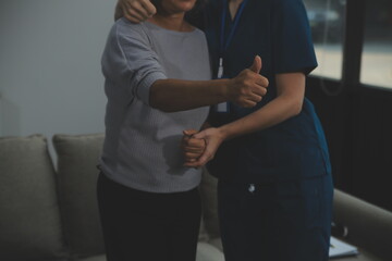 Female caregiver doing regular check-up of senior woman in her home.