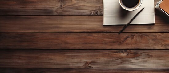 On a wooden table there is a notepad with sketches of ideas along with a coffee cup and a pencil The arrangement allows for plenty of empty space in the image. with copy space image