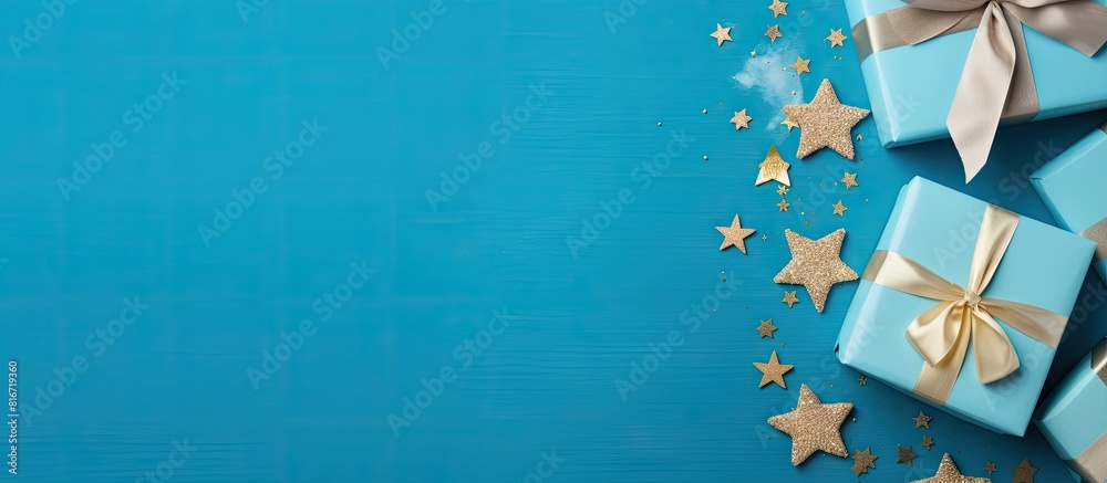 Aufkleber A top view of a blue table background with a gift box and various color paper decorations creating a design concept perfect for Father s Day The image has ample copy space