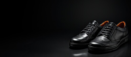 A stylish copy space image featuring men s shoes against a sleek black background showcasing the latest fashion trends