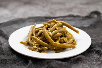 Boiled green beans on white plate