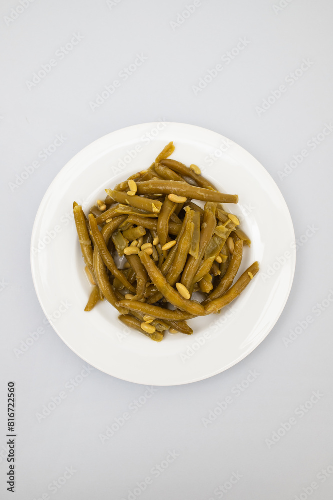 Sticker boiled green beans on white plate