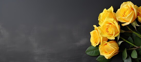 Yellow roses bouquet on a textured gray background with space for text or image. with copy space image. Place for adding text or design