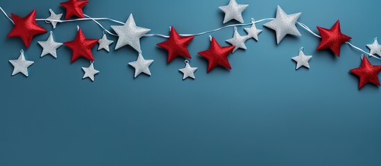 Top view of a festive Christmas decoration featuring silver and red stars on a vibrant blue background Perfect for a copy space image