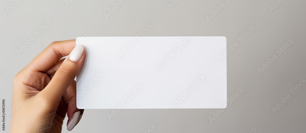 Poster a white prepaid card is held by a woman s hand against a white background with ample empty space for