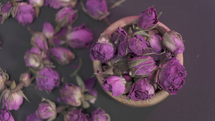 Dried rose buds on dark background. top view