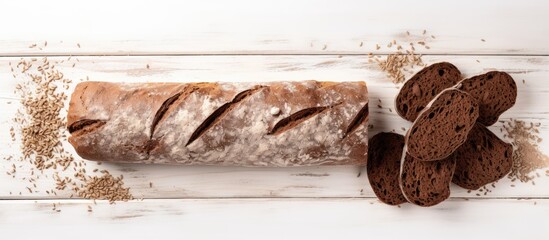 Copy space image of a top view brown loaf of whole grain bread and baguette made from whole grain flour on a white wooden background