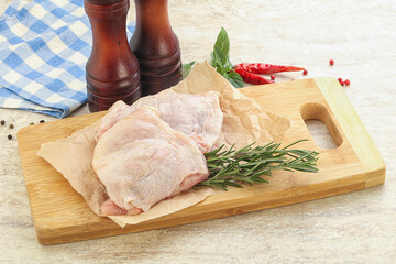 Raw chicken thighs over board