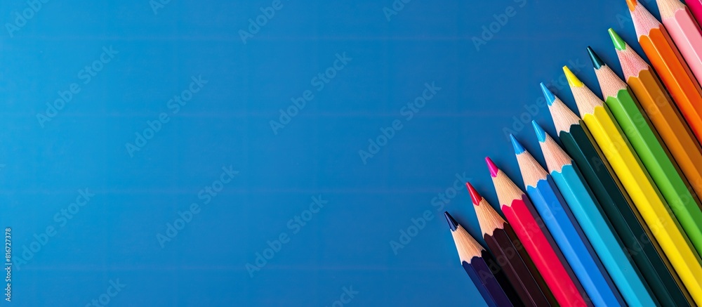 Aufkleber Top view of color pencils on a blue background with plenty of copy space image