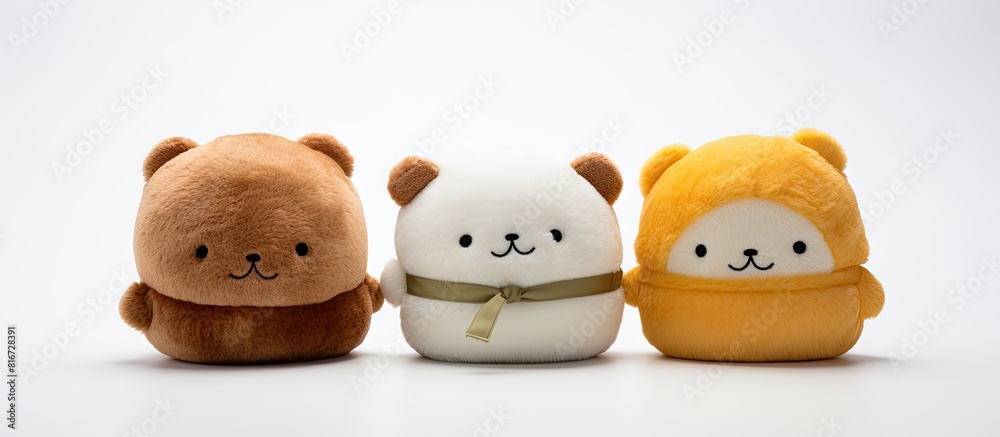 Aufkleber Three small Panettone plush toys arranged on a white background with copy space image
