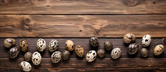 A top down view of quail eggs on a wooden table with plenty of empty space for adding text or other elements in the image. with copy space image. Place for adding text or design