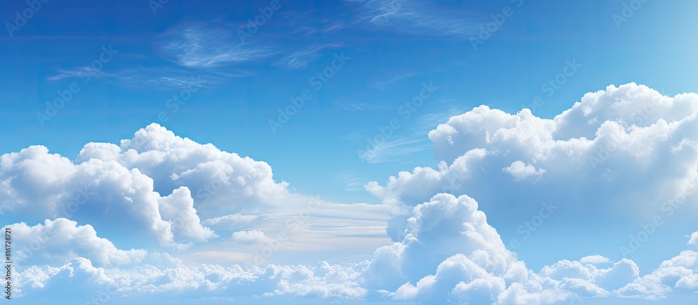 Poster The spacious blue sky is adorned with large billowing white clouds creating an ideal copy space for adding text