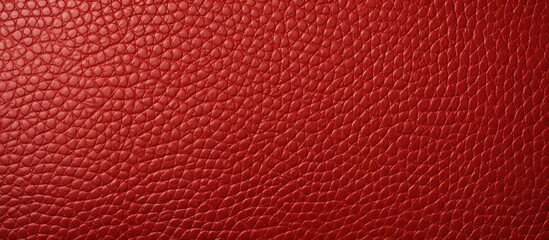 Fototapeta premium A copy space image of a textured surface in a vibrant red leather material