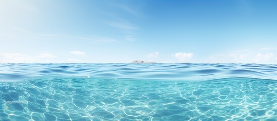 Obraz premium A serene clear sea creates a wide horizontal copy space image perfect for print or web banners with a white room for text The panoramic view offers a calming and relaxing background surface water tex