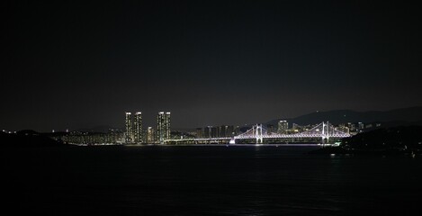 Breathtaking view of a picturesque bridge illuminated at night in the city of Busan, South Korea