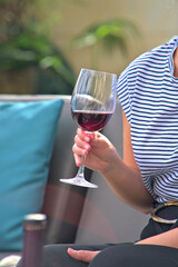 Enjoying a Glass of Red Wine in a Cozy Outdoor Setting