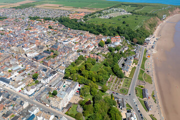 Aerial photo of the beautiful town of Filey in Yorkshire the UK, showing the sandy beach front and the residential housing estates on a sunny summers day