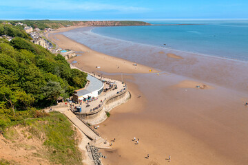 Aerial drone photo of the beach front in the town of Scarborough in North Yorkshire, England UK showing people relaxing and having fun on the beach on a sunny summers day