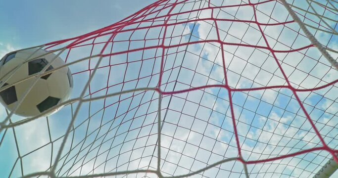Soccer field impressions - A soccer ball hitting the net and scoring a goal - Low-angle slow-mo, filmed from behind the goal and directly below