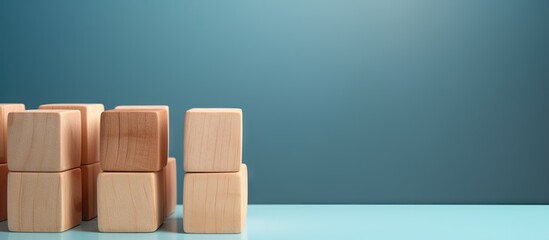 Wooden blocks with a check mark symbol set against a blue background create a checklist concept with ample copy space for additional content