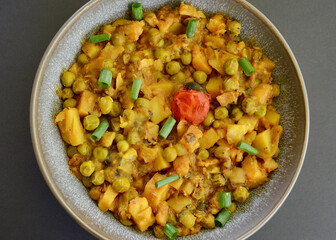 An Indian style spiced peas and potato dahl with slices of shallot.