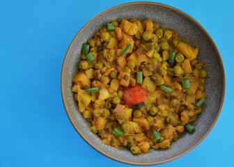 An Indian style spiced peas and potato dahl with slices of shallot.