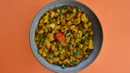 An Indian style spiced peas and potato dahl with slices of shallot.