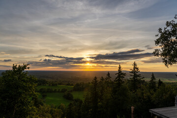 Scenic landscape of a sunset sky over the lush trees of Nolberget, Sweden