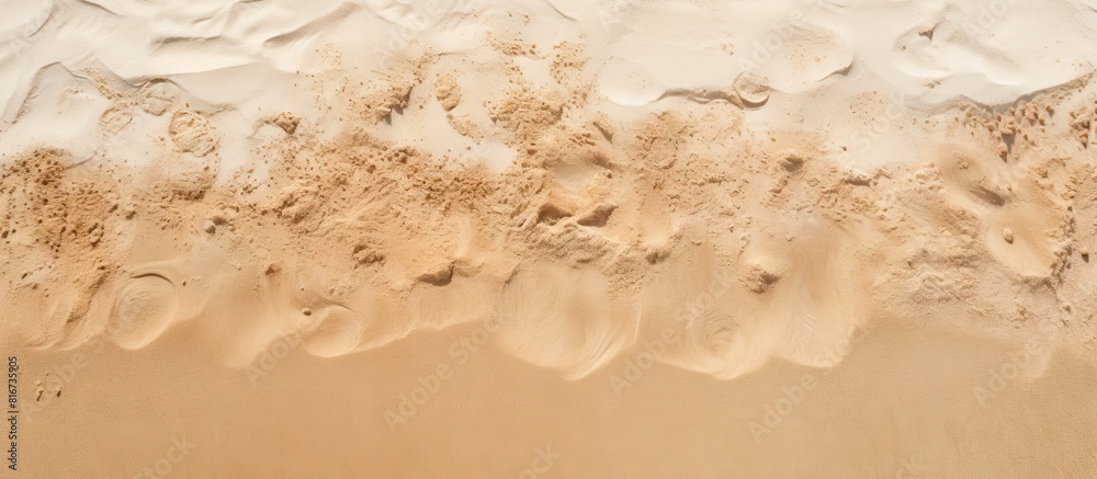 Aufkleber Top view of a sandy beach featuring a textured sand surface that serves as an ideal background for a copy space image