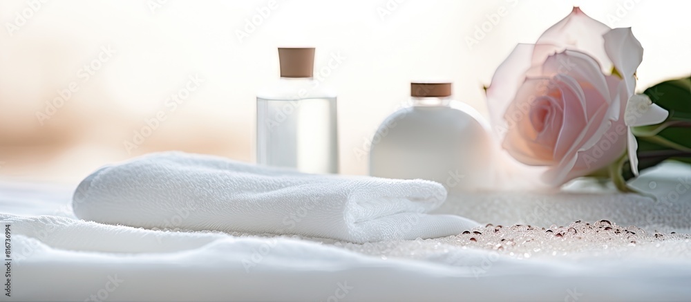 Poster copy space image of a stunning spa arrangement consisting of essential oil sea salt and rose placed 