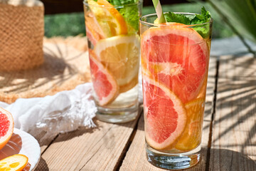 Summer refreshing lemonade drink with grapefruit, lemon, orange slices and mint. Fresh healthy cold...