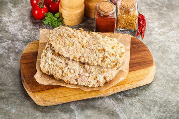 Breaded raw breaded meat schnitzel