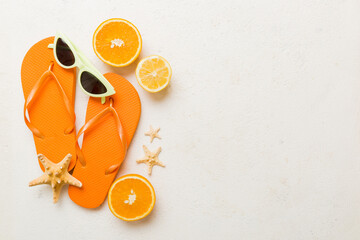 Top view composition of flip flops placed with beach accessories top view on table background....