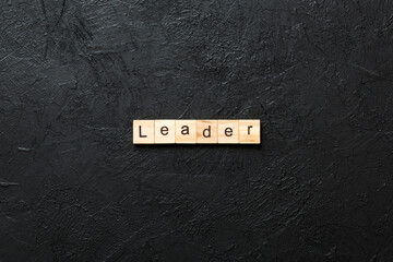 leader word written on wood block. leader text on cement table for your desing, concept