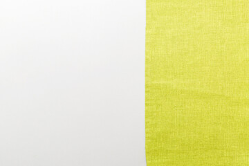 Fototapeta premium top view with green kitchen napkin isolated on table background. Folded cloth for mockup with copy space, Flat lay. Minimal style