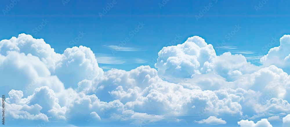 Poster The image shows a clear blue sky with fluffy white clouds in the background. with copy space image. Place for adding text or design