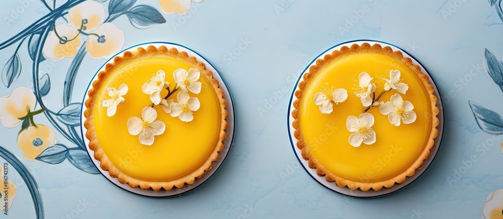 Poster top view of two beautifully decorated lemon curd tarts with plenty of copy space image