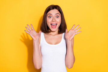 Photo of pretty impressed lady dressed white top screaming rising arms open mouth isolated yellow color background