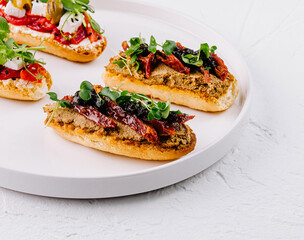 Gourmet bruschetta trio on elegant white plate