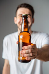 happy man holds bottle of beer