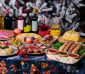 Festive holiday dinner table spread with various dishes