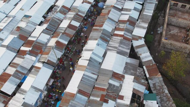 Ascending drone footage of a local market at sunset in Arusha city in East Africa's Tanzania