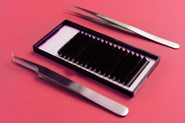 Professional eyelash extension tools on red background