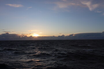 Cruise across the turbulent Atlantic Ocean at dusk