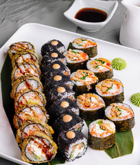 Assorted sushi rolls platter with dipping sauce