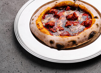 Artisan pepperoni pizza on white plate