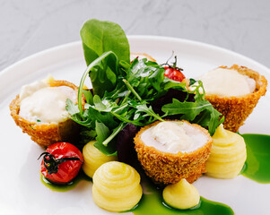 Gourmet goat cheese salad on white plate