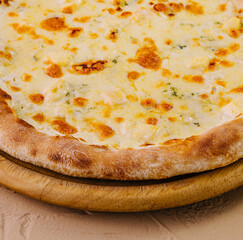 Fresh baked cheese pizza on wooden board
